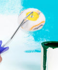 Double Ended Paint Roller And Corner Brush Tool For Wall And Trim Jobs handles tricky corners with a fuzzy roller on a handle.