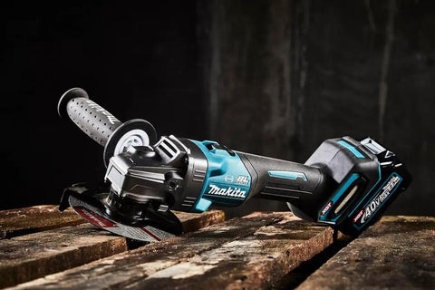 Badass Cordless Angle Grinder Kit Including Dual 40V Max Batteries And Smart Charger For Swift 125mm Metal Cutting Hella Lightweight Yet Serious Powerhouse Tool on wooden surface.