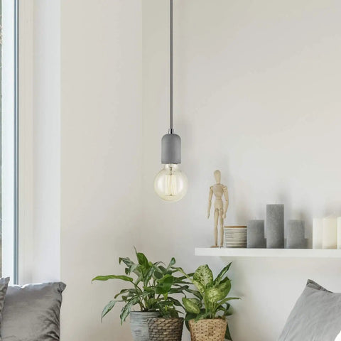 Old School Edison G30 Globe Vanity Light Bulb 60W Incandescent Filament E26 Base hanging in a minimalist room setting