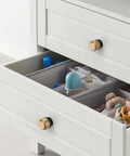 Two Pack Matte Black And Champagne Bronze Knurled Cabinet Knobs on white dresser drawer
