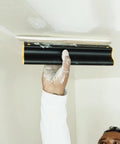 Pro Grade 16 Inch Drywall Skimming Blade With Extruded Aluminum Back And European Stainless Steel Blades in use on ceiling