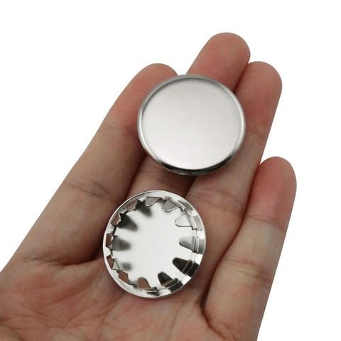 12 Pack Stainless Steel Knockout Plugs For Electrical Boxes Featuring Knurled Grip And No Sweat Tap In Install Rock Solid Seal Keeps Your Panel Jobs Hella Slick in hand showing top view and interior detail.