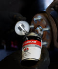 Mechanic applying Premium 4oz Brush Top SIL Glyde Silicone Brake Grease for Calipers and Brake Lubrication by AGS Automotive Solutions