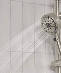 Precept Slide Bar With Brushed Nickel Finish showing water spray from hand shower