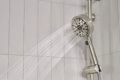 Precept Slide Bar With Brushed Nickel Finish showing water spray from hand shower