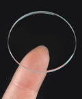 Six Pack Watch Crystal Lenses 32.5mm Diameter Round Flat Mineral Glass Replacement Parts For Watch Repair shown on fingertip