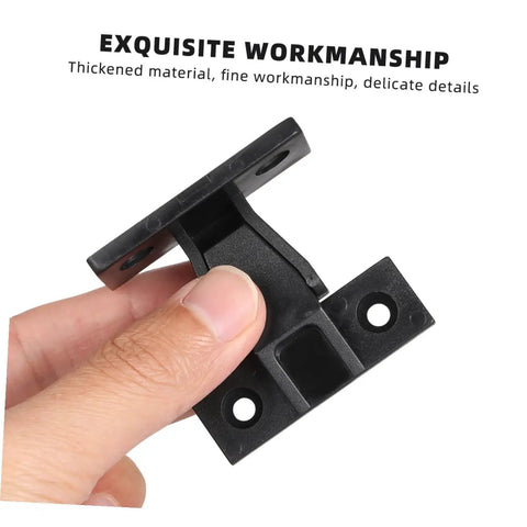 Hand holding a black concealed push on corner connector for wooden furniture and cabinets, showcasing fine craftsmanship.