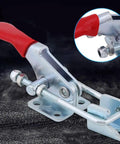 Four Piece Heavy Duty Toggle Clamps Set With Quick Acting Release Latch And No Fuss Adjustable Base close-up of metal clamp with red handle.