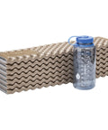 Z Lite Original Camping And Backpacking Sleeping Pad Lightweight Closed Cell Foam Ground Pad With Accordion Fold next to water bottle