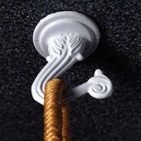 Jumbo Swag Hook With Hardware White Enamel mounted on wall holding rope, features ornate white design with easy installation hardware