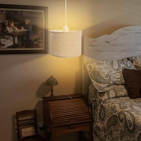 Plug In Pendant Light With 15 Ft Clear Cord Beige Linen Shade On Off Switch Hanging Ceiling Light For Bedroom Living Room Dining Area Cozy Vibe And Easy Height Adjustment displayed over a bedside area with wooden furniture and patterned bedding