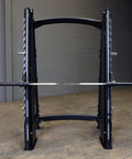 Pro Clubline Counter Balanced Smith Machine Featuring Heavy Duty Safety Stops Built Tough For Hardcore Home Gym Gainz And Commercial Powerlifting Rigs, front view showing steel construction and bar.