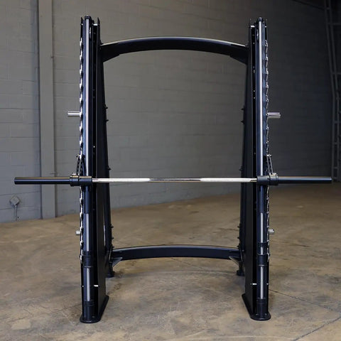 Pro Clubline Counter Balanced Smith Machine Featuring Heavy Duty Safety Stops Built Tough For Hardcore Home Gym Gainz And Commercial Powerlifting Rigs, front view showing steel construction and bar.