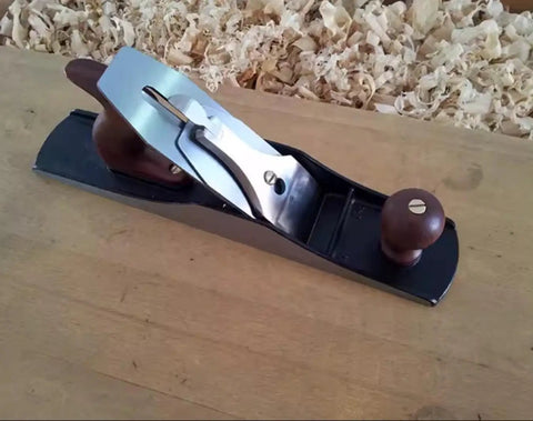 Professional Grade Number 5 1/2 Jointer Bench Plane With Hella Sharp Steel Blade on wooden surface for carpentry use.
