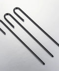 Four Extra Heavy Duty Rebar U J Hook Ground Anchors 12 Inch By One Quarter Inch Rust Proof Coated Steel shown on a surface