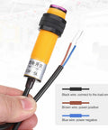 Close-up of Dope Through Beam M18 Photoelectric Sensor Kit 2 Pack, 10-30V DC, with wires labeled black, brown, and blue for connectivity.