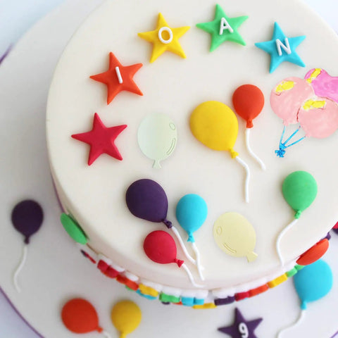 Decorated cake with colorful fondant balloons using Balloon Silicone Molds Set Of 5 For Cake Decorating And Candy Making.