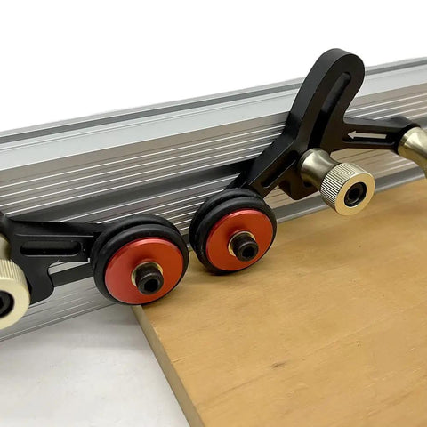 Close-up of Upgraded Router Table Saw Roller Feeder With One Way Bearings And Anodized Aluminum Body, showcasing smooth rollers and clamp.