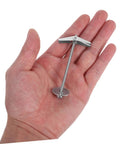 Hand holding a toggle bolt from 15-Piece Heavy Duty Toggle Bolts And Wing Nuts Kit For Drywall, Wood Panels, Hollow Brick Walls