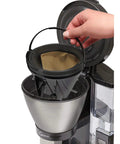Hand holding Gold Tone Permanent Coffee Filter For 12 Cup Coffee Makers Including Krups Savoy Braun DeLonghi Easy Clean