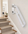 Slick Flip Up U Shaped Stair Handrail Wall Mount Railing For Steps With A Beefy Folding Grab Bar and Rock Solid Armrest For Indoor Outdoor Spaces mounted on wall near stairs.