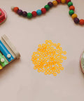 100 Pack Miniature Plastic Bushings and Axle Sleeves for Toy Vehicles surrounded by colorful toys on a table.
