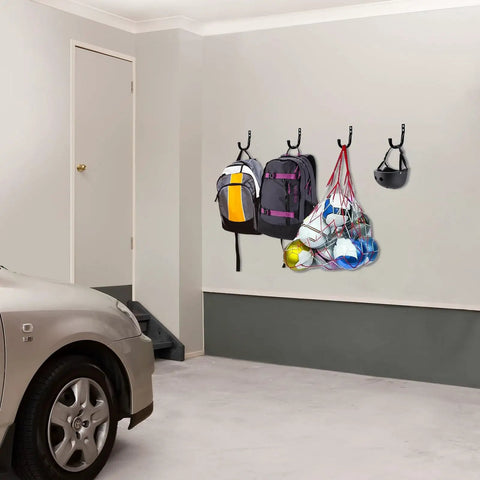 Garage with Beefy Heavy Duty Metal Wall Hooks Set Six Pack For Garage Organization And Storage holding backpacks and sports gear.