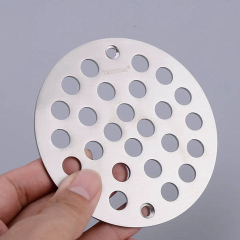 Hand holding 4 Inch Screw-In Shower Drain Cover Replacement Floor Strainer in Brushed Stainless Steel with high-flow grate design.
