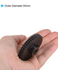 Hand holding Mod 1 48T Pinion Gear With 8mm Bore For RC Cars And Trucks, Hardened 45 Carbon Steel, 50mm diameter visible.