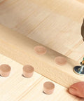 Close-up of Khaki Wood Plugs Set For Woodworking And Diy Projects Natural Finish Hardwood Hole Caps near screw, hand holding wood.