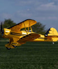 UMX Waco Yellow RC Airplane Bind-N-Fly BNF With AS3X And Safe Technology in flight against blue sky