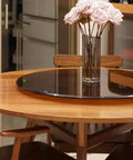 35 Inch Heavy Duty Lazy Susan Turntable Boasting Smooth Rolling Action Tempered Glass Top on a wooden table with flowers.