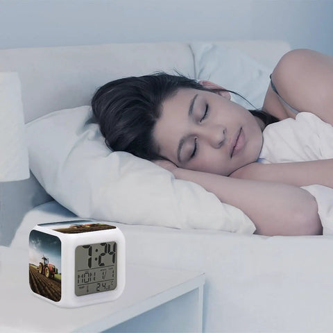 Tractor Farm Alarm Clock With LED Display And 7 Color Night Light for Bedroom on nightstand next to sleeping person
