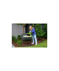 Person using the 48 Gallon Dual Compartment Compost Tumbler with No-Fuss Turn and Continuous Cycle in a garden setting.