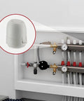 Close-up of white 24V electric thermal actuator (normally closed) with IP54 rating on underfloor heating manifold.