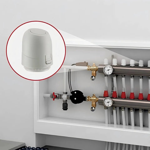 Close-up of white 24V electric thermal actuator (normally closed) with IP54 rating on underfloor heating manifold.