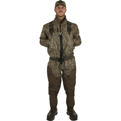 Model wearing Men's Insulated Guardian Elite Front Zip Wader with TiZIP MasterSeal 10 and boots in Mossy Oak Bottomland