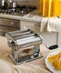 Level Up Your Kitchen Game With This No Sweat Hand Cranked Noodle Maker And Multi Function Dough Roller Press crafted for cutting noodles and rolling dough quickly in a kitchen setting.