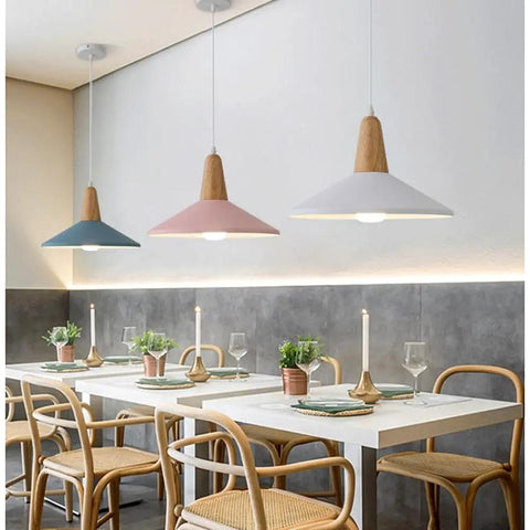 KCEYANB Adjustable Height Pendant Light Modern Simplicity Metal Hanging Lamp in blue, pink, and white shades over a dining table.
