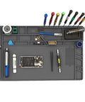 Top view of Extra Large Silicone Soldering Mat 21.6 By 13.8 Inches, Heat Resistant Up To 932 Degrees Fahrenheit with tools and phone