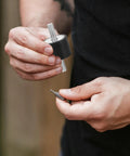 Person holding Four Piece Built For The Grind Anti Vibration Rubber Studs M10 Double Screw Mount with tool.
