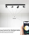 Illustration showing GU10 Smart RGB LED Bulbs Pack of 4 No Hub Required Dimmable Via App Works with Alexa and Google Assistant 2.4G WiFi Only 50W Equivalent Track Lighting Color Changing LED Bulbs for Home being grouped and controlled via smartphone app.