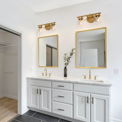 Bathroom interior with two Two-Light Gold Vanity Light With Clear Globe Glass Shades Over-Mirror Fixture In Hand-Painted Gold Finish