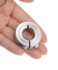 Hand holding a Four Pack Five Eighth Inch Split Clamp-On Shaft Collar with One and Five Sixteenths Inch Outer Diameter, 304 Stainless Steel.
