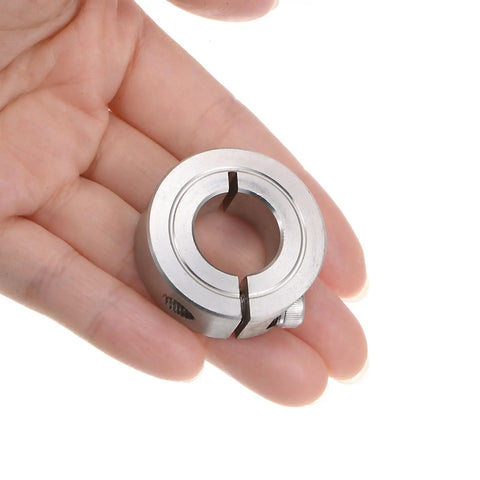 Hand holding a Four Pack Five Eighth Inch Split Clamp-On Shaft Collar with One and Five Sixteenths Inch Outer Diameter, 304 Stainless Steel.