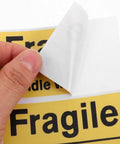 Yellow Fragile Stickers For Small Business Packaging 6 Pack High Visibility PVC Adhesive Labels For Shipping Moving Warehouses Parcels Luggage And Handling Durable Fragile Warning Signs For Safe Delivery, peeled corner view