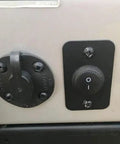 Close-up of installed waterproof round rocker switch on off 12V DC 20A and 125V and 250V AC SPST 20mm toggle, black and lightless.
