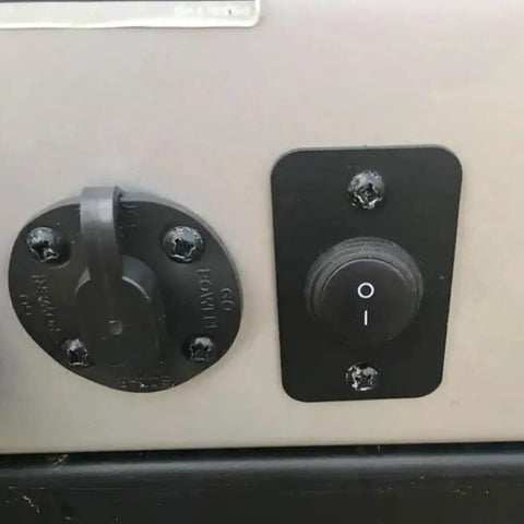 Close-up of installed waterproof round rocker switch on off 12V DC 20A and 125V and 250V AC SPST 20mm toggle, black and lightless.