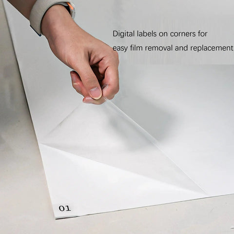 Person peeling back a layer of Heavy Duty 300 Sheet Adhesive Tacky Mats For Sweeping Dust Dirt And Grit Off Boots And Equipment Wheels.