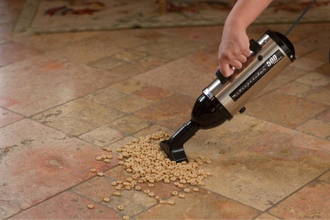 Evolution Hand Vacuum Portable 120V 504W with all steel construction cleaning cereal from tile floor